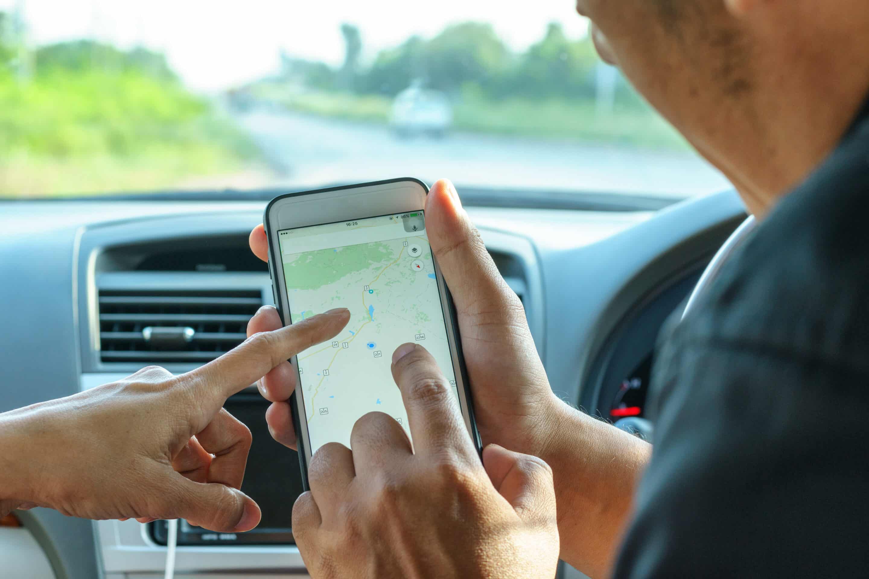 people searching directions on map in application on mobile device