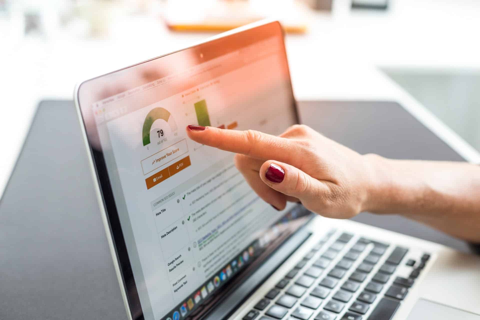 hand pointing at computer screen